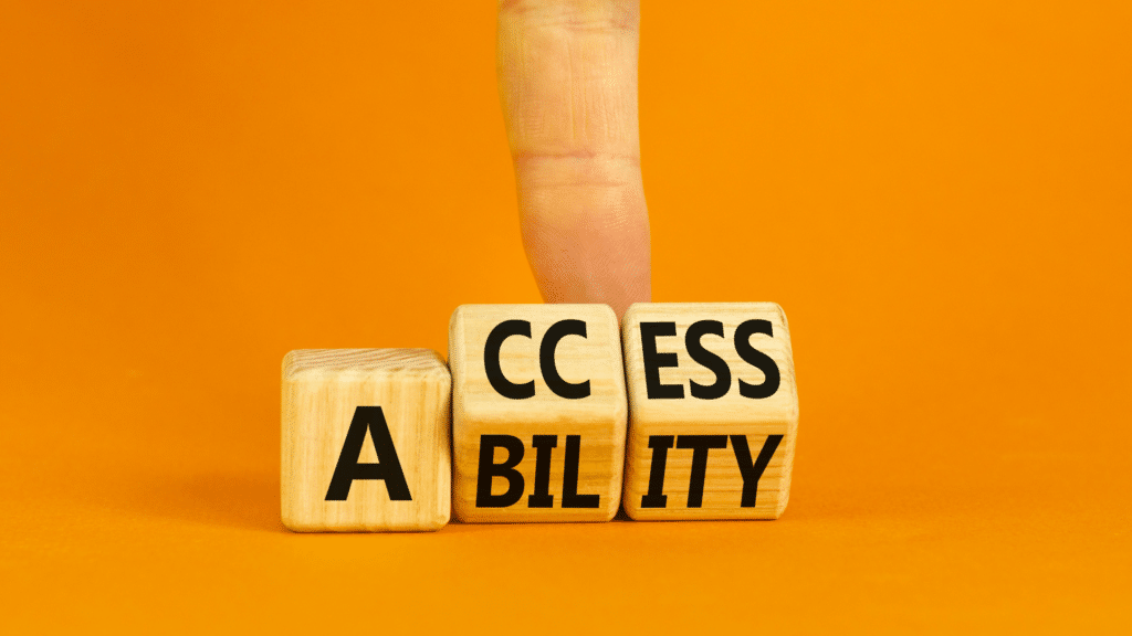 Wooden blocks with the word "accessibility" written on it and a finger above it.