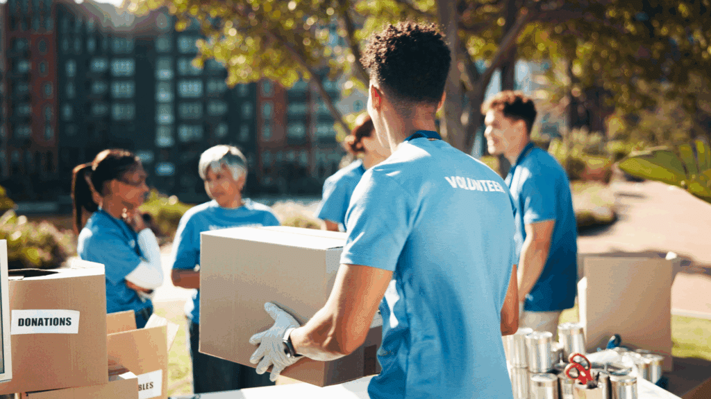volunteers carrying boxes outdoors